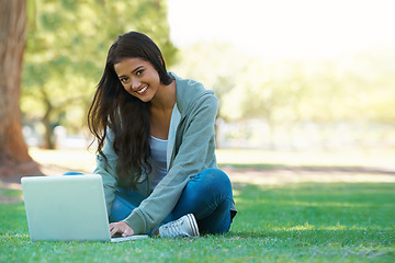 Image showing College, woman and typing on laptop in park with research, project or learning outdoor on campus. University, student and girl studying online with ebook, education and computer on lawn in garden