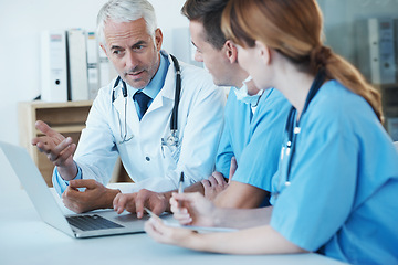 Image showing Laptop, meeting and doctor with nurses in hospital for medical diagnosis or treatment discussion. Team, computer and senior surgeon talking to healthcare workers for surgery research in clinic.