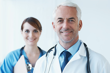 Image showing Smile, portrait and doctor with nurse in hospital with clipboard for medical research in collaboration. Happy, checklist and senior male surgeon with healthcare worker in clinic for teamwork.