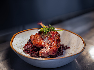 Image showing Roast duck leg served with red cabbage
