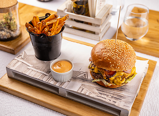 Image showing Burger and fried potatoes