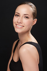 Image showing Studio, portrait and make up of woman with happiness, cosmetic and facial treatment on black background. Model, smile an spa cosmetology for beauty with glow face, bodycare and retinol for soft skin