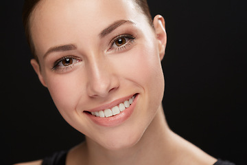 Image showing Woman, closeup and portrait in studio with cosmetics, happiness and beauty results of cosmetology in mockup. Model, face and skincare with retinol for glow, collagen and make up on black background