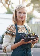 Image showing Gardening, seedling and portrait of woman with plants for landscaping, planting flowers and growth. Agriculture, nature and face of person outdoors for environment, ecology and nursery in garden