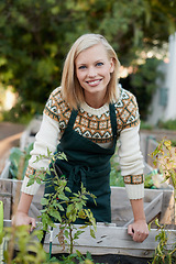 Image showing Gardening, backyard and portrait of woman with plants for landscaping, planting flowers and growth. Agriculture, nature and face of person outdoors for environment, ecology and nursery in garden