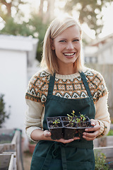 Image showing Garden, happy and portrait of woman with plants for landscaping, planting flowers and growth. Agriculture, nature and person with seedlings outdoors for environment, ecology and gardening in nursery