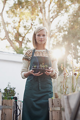 Image showing Gardening, morning and portrait of woman with plants for landscaping, planting flowers and growth. Agriculture, nature and face of person outdoors for environment, ecology and nursery in garden