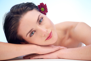 Image showing Portrait, skincare or woman with beauty, skincare or natural glow relaxing while isolated on studio background. Model, face and wellness with dermatology, cosmetics and facial products with flower