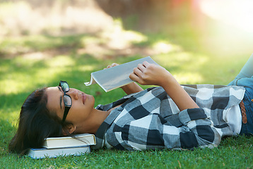 Image showing Relax, grass or woman in park reading book for learning knowledge, information or education. Thinking, textbook or female student in nature for studying history, story or novel on college campus lawn