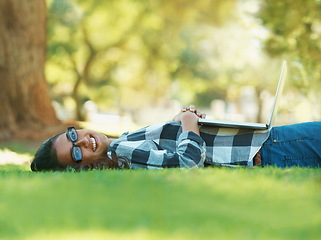 Image showing Woman, park and laptop for study, learning and education for summer, college and portrait. Latino student, nature and new york trees with smile, lawn and lying down for happy, relaxing and sunshine