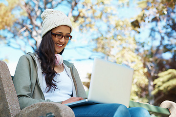 Image showing Woman, typing and college student on laptop in park with research, project or learning on campus. University, education and girl reading online with ebook on computer and study in garden with nature