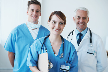 Image showing Happy, portrait and doctor with nurses in hospital with clipboard for medical research in collaboration. Smile, checklist and senior male surgeon with healthcare workers in clinic for teamwork.