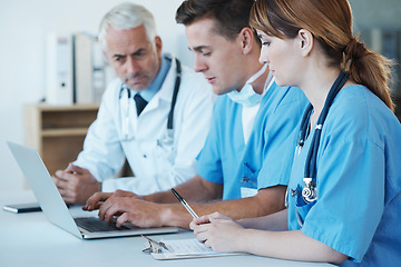 Image showing Computer, meeting and doctor with nurses in hospital for medical diagnosis or treatment discussion. Team, laptop and senior surgeon talking to healthcare workers for surgery research in clinic.