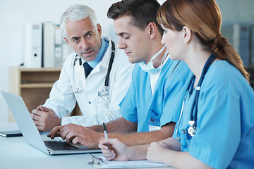 Image showing Laptop, discussion and doctor with nurses in hospital for medical diagnosis or treatment meeting. Team, computer and senior surgeon talking to healthcare workers for surgery research in clinic.