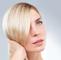 Image showing Hair care, hand and beauty of blonde woman in makeup, thinking and isolated on a white studio background. Face, touch and hairstyle of serious model in cosmetics, hairdresser and salon treatment