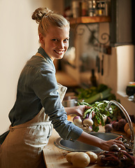Image showing Woman, portrait and washing of vegetables and healthy food for hygiene, cooking or preparation by sink in kitchen. Happy person with water and green onion to start dinner or organic and vegan lunch