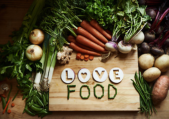 Image showing Vegetables, empty and cutting board for food background, cooking and preperation of ingredients or recipe on table. Culinary, organic and green groceries for vegan with love, health or wellness above