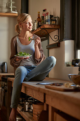 Image showing Thinking, woman and eating salad in home kitchen, nutrition and fresh leafy greens for healthy diet. Food, bowl and smile of hungry person with vegetables, lunch or organic vegan meal for wellness