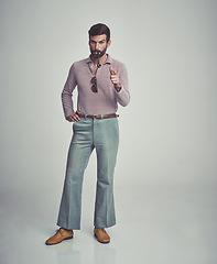 Image showing Vintage, fashion and portrait of man with 70s retro aesthetic in gray background of studio. Smoking, pipe and serious person with confidence and pride in funky clothes and unique style from past