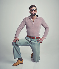 Image showing Vintage, fashion and portrait of man with 70s retro aesthetic in gray background of studio. Smoking, pipe and person with confidence and pride in funky sunglasses, clothes and unique style from past