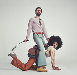 Image showing Vintage, man and woman or riding crop in studio with piggyback, portrait and funny face for retro style. Friends, people and 70s outfit with hipster clothes or comic expression with white background