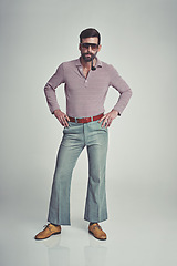 Image showing Vintage, fashion and portrait of man with 70s retro aesthetic in gray background of studio. Smoking, pipe and person with confidence and pride in funky sunglasses, clothes and unique style from past