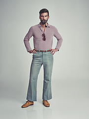 Image showing Retro, fashion and portrait of man with 70s vintage aesthetic in gray background of studio. Smoking, pipe and person with confidence and pride in funky clothes and unique style from past or history