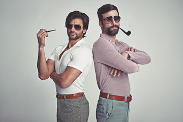 Image showing Fashion, men and sunglasses or pipe in studio with vintage model, hipster outfit and confidence with arms crossed. Friends, people and attitude with 70s style or retro clothes with white background