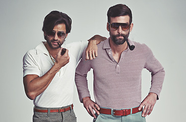 Image showing Fashion, men and sunglasses or pipe with vintage model, hipster outfit or confidence with calm expression in studio. Friends, people and attitude with 70s style or retro clothes with white background