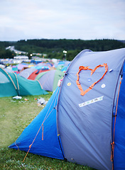 Image showing Camping, festival and heart on tent at evening outdoor for event, party or celebration in nature. Field, forest or grass with shelter from weather on sky at campsite for adventure or getaway