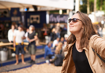 Image showing Event, festival or party with woman outdoor on blurred background of audience or crowd for social gathering. Face, smile and happy with confident young person at gathering for celebration in summer