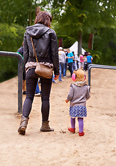 Image showing Festival, queue and mother with daughter in forest for event, party or social gathering outdoor in summer. Family, kids and woman parent with girl child in nature, park or woods together from back