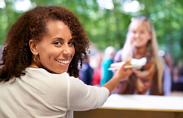 Image showing Portrait, smile and black woman serving customer at outdoor event, festival or party for celebration. Face, small business and fast food with happy young kiosk owner in forest or park for hospitality