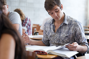 Image showing College, books and man in classroom reading for development in learning, opportunity and future. Education, knowledge and growth for ambitious university student in lecture, studying for exam or test