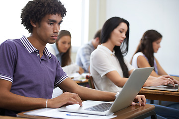 Image showing University, laptop and man in classroom typing with research, learning and future opportunity. Education, knowledge and computer with group of students in college lecture studying for online exam.