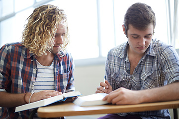 Image showing Men, students and reading textbook in college with teamwork for education assignment, project or research. Male people, friends and group studying in university for lecture or learning, notes or exam