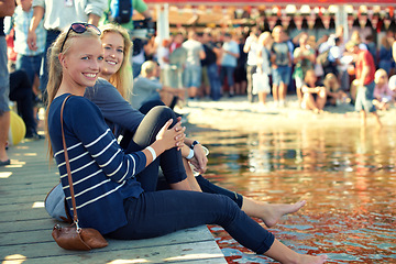 Image showing Women, festival and crowd for portrait, smile and fun with happiness, pond and water. Couple of friends, audience and nature with summer, texas and event or concert with party, people and music