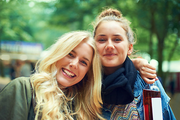 Image showing Portrait, music festival and women with a bottle of wine, hug and smile with happiness and bonding together. Face, people or outdoor with friends or alcohol with weekend break or excited with embrace