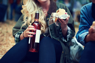 Image showing Snack, woman and music festival with friends, beer and happiness with joy and bonding together. Alcohol, outdoor and girl with fast food or takeaway with summer break or concert with culture or event