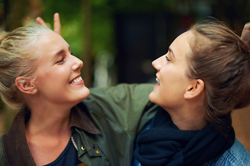 Image showing Women, happy and smile in forest for connection, bonding and unity outdoors together in nature. Female friends, gaze and affection in woods for walk, socialising and adventure with joy in Australia