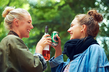 Image showing Friends, cheers and drinks at music festival in forest, excited and beer for bonding together by trees. Women, drinking and celebration in summer on holiday adventure and reunion by concert in woods