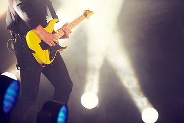 Image showing Guitar, stage and man at music festival, concert or live event in Amsterdam. Musician, artist and electric instrument with lights and playing for audience, crowd or spectators at night for enjoyment