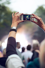 Image showing Hands, cellphone and picture at music concert in crowd for social media post for holiday, carnival or celebration. Person, photography and summer event for travel party or forest, camping or festival