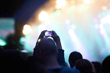 Image showing Hands, cellphone and photography at music concert in crowd for social media post for holiday, carnival or night. Silhouette, photo and summer event or travel party or dark outdoor, lights or festival