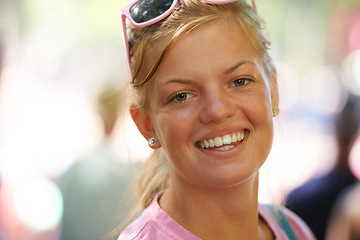 Image showing Woman, portrait and happy at festival in nature, excited and travel leisure for wellness in forest. Young person, happiness and face outdoor at carnival in bokeh, relax and summer holiday in europe