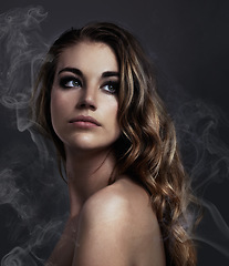 Image showing Woman, thinking and makeup, beauty and smoke with hair, cosmetics and balayage on grey background. Serious model, edgy with haircare and vapor, cosmetology and dream with mist or fog in studio