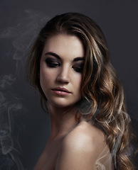 Image showing Woman, eyeshadow and makeup, beauty and smoke with hair, cosmetics and balayage on grey background. Serious model, edgy with haircare and vapor, cosmetology and skin with mist or fog in studio