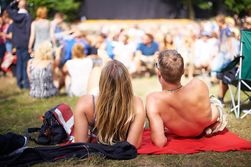 Image showing Couple, crowd and concert for festival, love and date with summer, nature and quality time. Man, woman and audience with sunshine, music and stage in park with romance, relationship and happiness