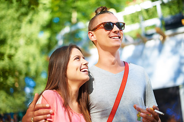 Image showing Hug, smile and couple at music festival outdoor, event and celebration on valentines day together in summer. Cigarette, man and happy woman at party, carnival and laugh in nature with drink at park