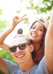 Image showing Portrait, piggyback and smile of couple with peace sign at music festival, event and celebration on valentines day together in summer. Face, man and happy woman with v hand gesture at party outdoor